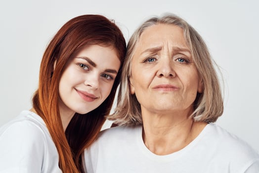 granddaughter and grandmother are standing next to family love studio photo