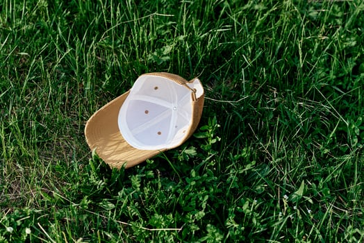 The sports cap lies on the fresh green grass photo