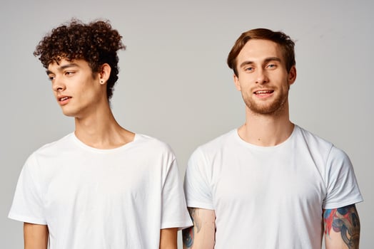 Two cheerful friends in t-shirts stand side by side isolated background joy photo