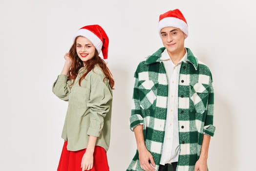 Man and woman in festive caps on a light background cropped view photo
