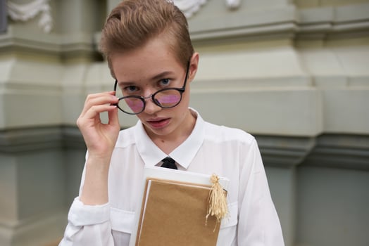 short haired woman with a book in his hands outdoors reading Lifestyle photo