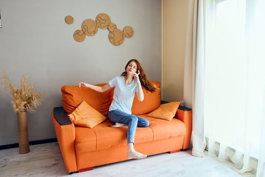 cheerful woman on the couch rest fun Comfort apartments photo