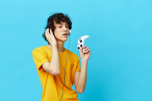 curly guy yellow T-shirt with joystick video games technologies photo