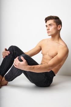 Handsome male naked torso sitting on the floor attractive look model photo