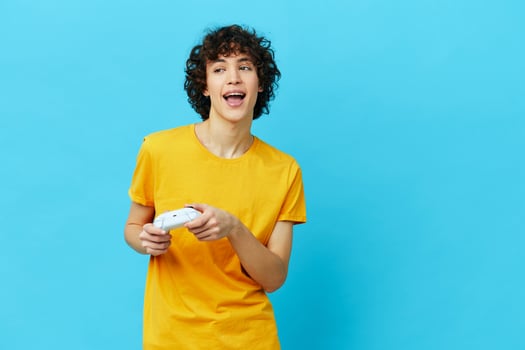 guy yellow T-shirt with joystick video games technologies photo