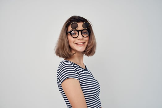 woman in striped t-shirt fashion glasses studio posing photo