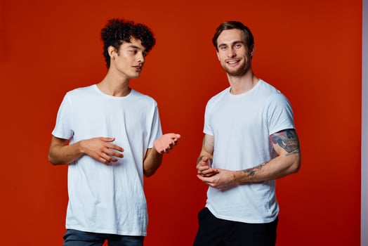 Two cheerful friends in white t-shirts communication isolated background fun photo