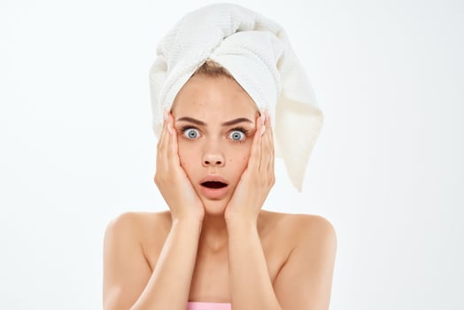 woman with a towel on her head skin care face dermatology hygiene photo