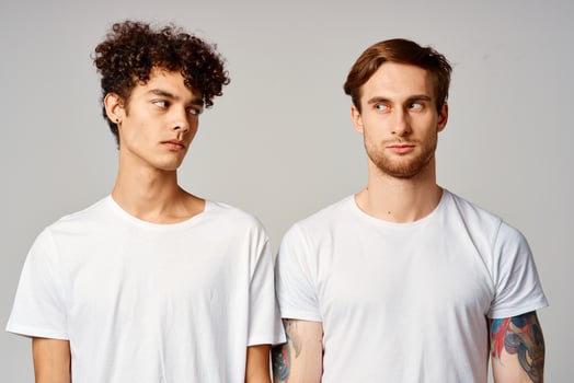 two men in white t-shirts are standing next to friendship emotions photo