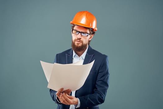 Emotional man in orange coloring drawings instruction manual construction work photo