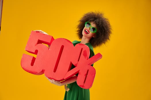 Pretty young female green dress afro hairstyle dark glasses fifty percent in hands studio model unaltered photo