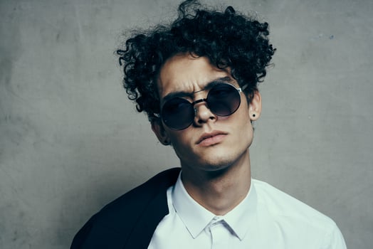 handsome guy model in shirt and glasses jacket on shoulder portrait close-up photo
