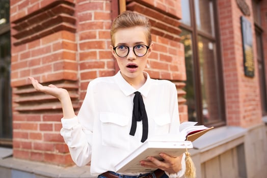 short haired woman with a book in his hands outdoors reading Lifestyle photo