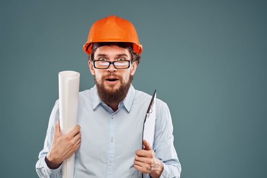 emotional man wearing glasses orange helmet safety blueprints in hands professional work photo