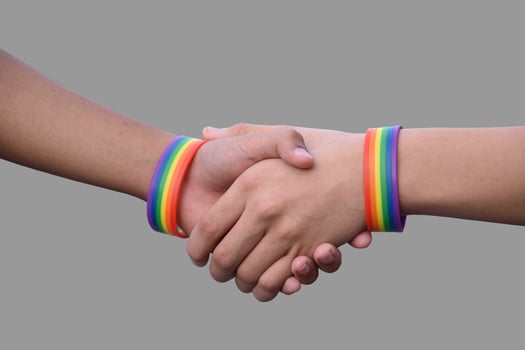 Isolated hands which wear rainbow wristband around them with clipping paths. photo
