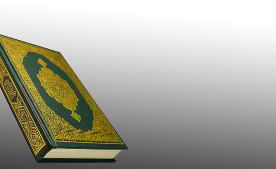 The Holy Al Quran with written arabic calligraphy meaning of Al Quran and rosary beads or tasbih on white background, isolated with copy space. photo