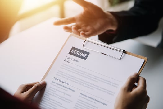 Close up view of job interview in office, focus on resume writing tips, employer reviewing good cv of prepared skilled applicant, recruiter considering application, hr manager making hiring decision photo
