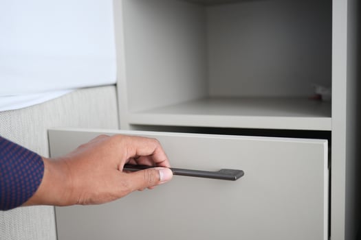 man's hand open drawer wooden in cabinet photo