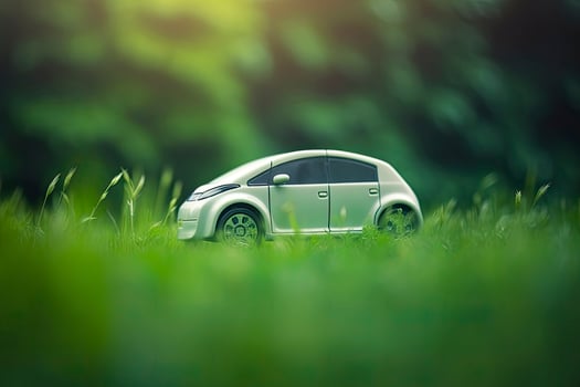 electric car with green leaf icon on blur grass background, ecology and environment concept photo