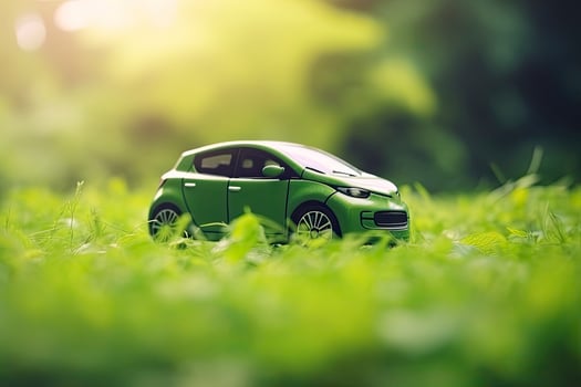 electric car with green leaf icon on blur grass background, ecology and environment concept photo