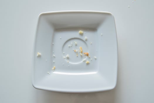 empty small square telekrzyk with crumbs after eating on a white background photo