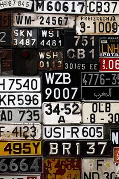 Various old car license plates from around the world at the museum photo