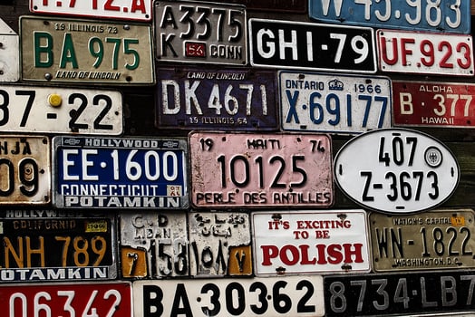 Various old car license plates from around the world at the museum photo