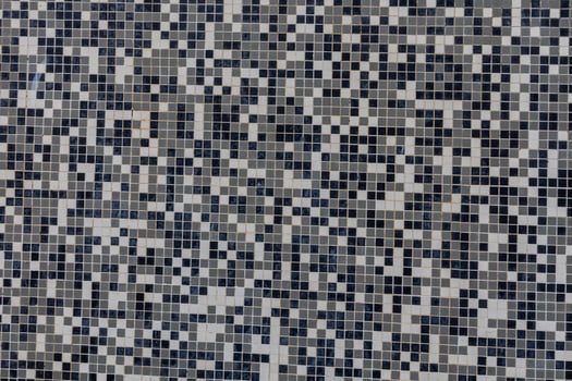 black and white background made of small square ceramic glaze tiles photo