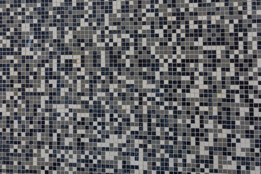 black and white background made of small square ceramic glaze tiles photo