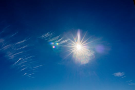 natural landscape background with blue sky, sun and white clouds photo