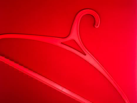 red hanger insulated with red background photo
