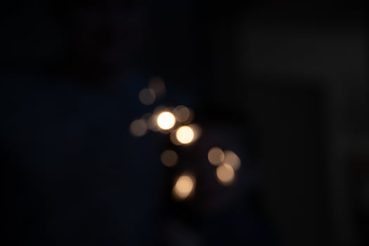 blurred golden light spots on a black background creating an interesting pattern photo