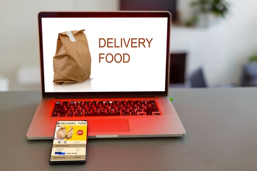 food order concept. Close-up top view of a coolhunter ordering food with a laptop. all screen graphics are made up. photo
