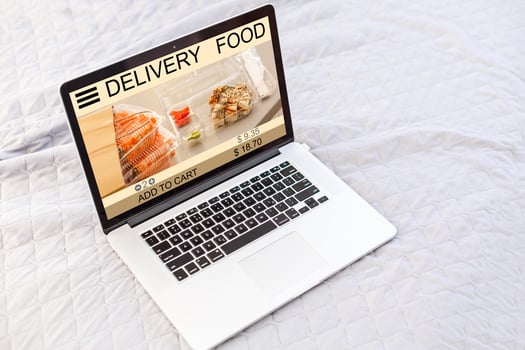 food order concept. Close-up top view of a coolhunter ordering food with a laptop. all screen graphics are made up. photo