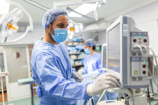 Medical ventilator being monitored by anaesthetist. surgeon using monitor in operating room. photo