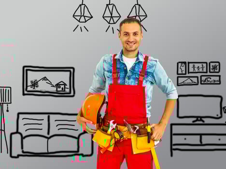 male worker in helmet. Repairman, handyman, tradesman over drawn home plan photo