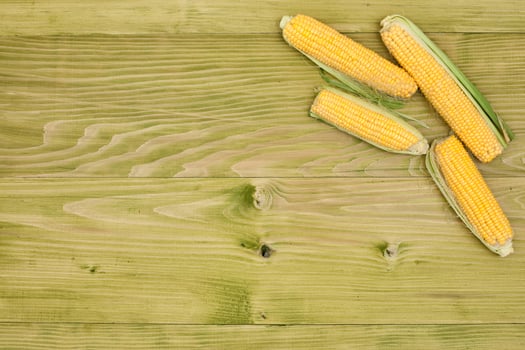 Organic corn on wooden board photo