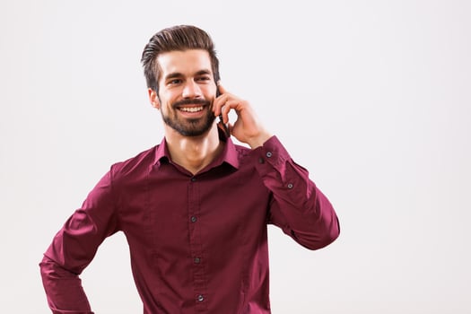 A man in a purple shirt on the phone photo