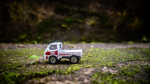 South Minahasa, Indonesia  January 2023, a toy car on a mossy floor that looks like grass photo