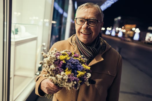 A man taking a walk through the city with flowers photo