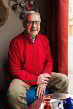 A senior man in a red sweater relaxing photo