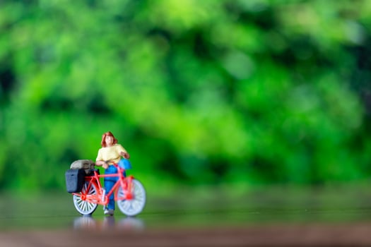 Miniature people standing with bike, World bicycle day concept photo