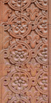 Ornate wall decoration with middle-east motives concept photo. Wase with flowers on the wall. Urban architectural photography. photo