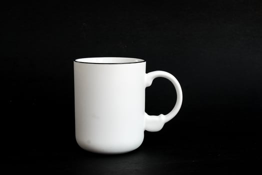 White mug. White cup with red heart for tea or coffee on background. photo