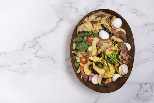 Organic garbage for compost on a marble background. Composting concept flat lay, top view photo