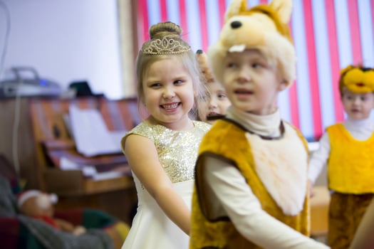 .Joyful girl at the Christmas party in kindergarten. photo