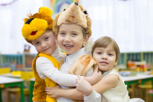 Morning party in kindergarten.Joyful children from kindergarten at Christmas morning. Little boys and girls in carnival costumes. photo