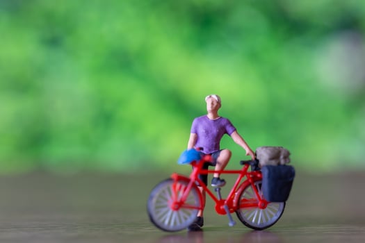 Miniature people standing with bike, World bicycle day concept photo