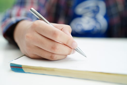 Asian teenage student write homework, study lesson for exam online learning education. photo