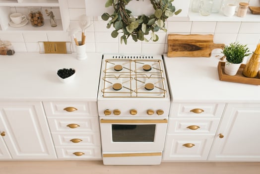 Modern new light wooden kitchen interior with white furniture and kitchen utensils photo